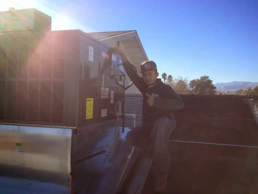 HVAC technician performing HVAC Inspection on a rooftop unit in Wilmington Island